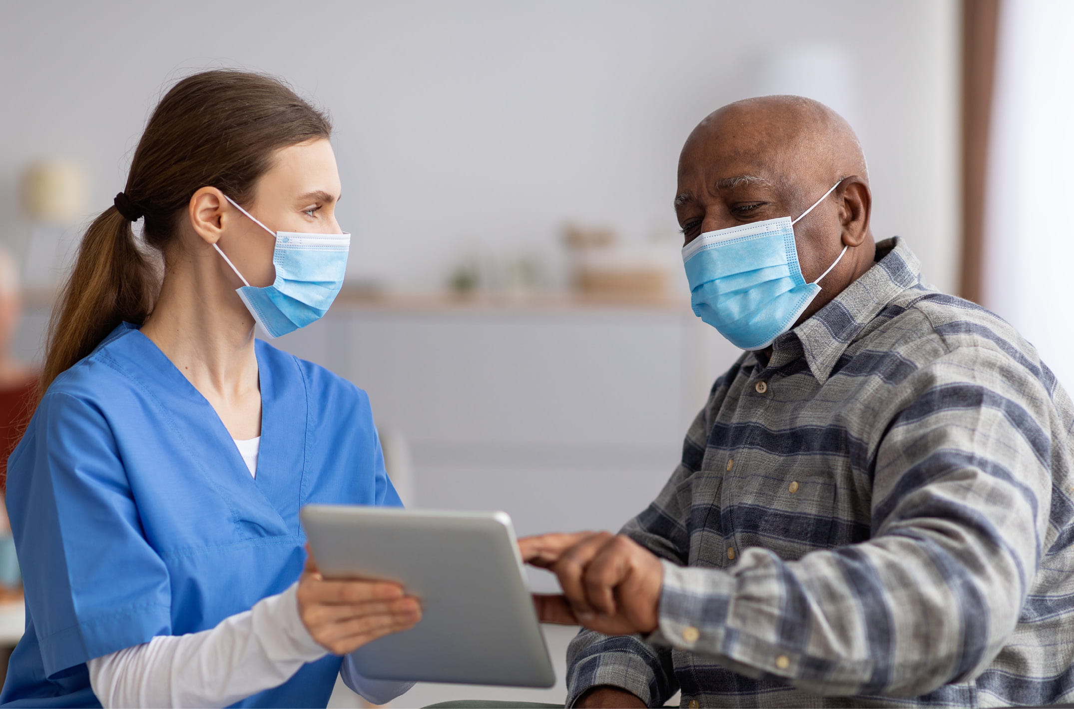 Masked nurse and older heavy set man